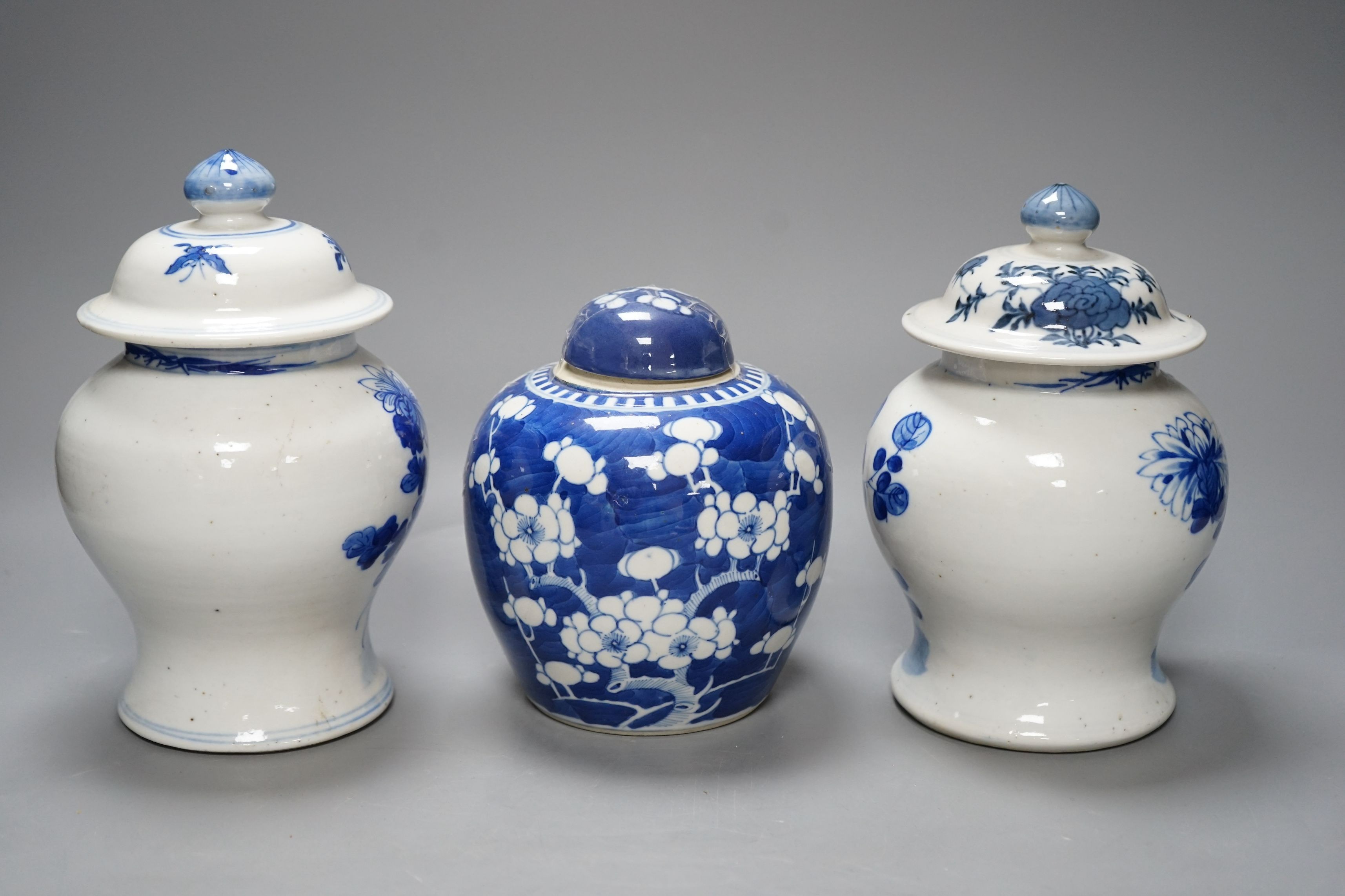 A pair of Chinese jars and covers and a prunus jar and cover circa 1900, jars and covers 21cms high